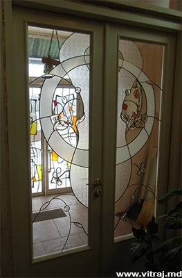 Stained glass in doors with faceted elements